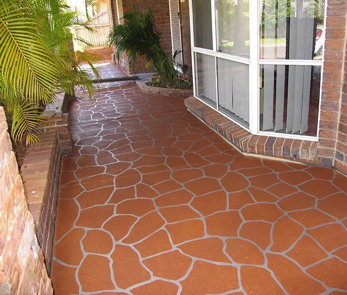 Terracotta cobblestone stencil pattern on a covered outdoor walkway