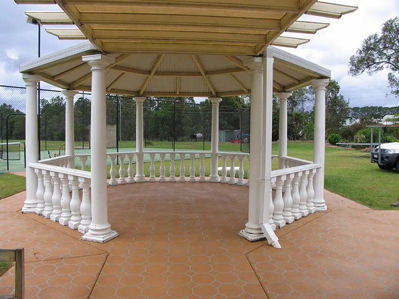 Terracotta patterned concrete surround beneath a white timber rotunda